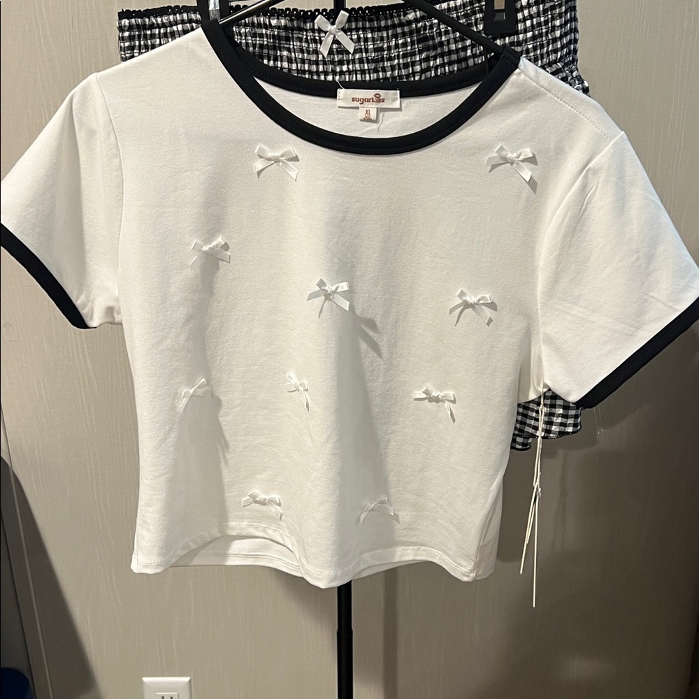 White T-Shirt with Black Trim and Bow Accents